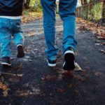 child and adult walking along together