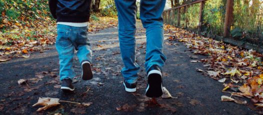 child and adult walking along together