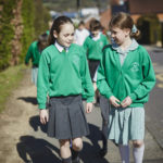 girls chatting whilst walking to school