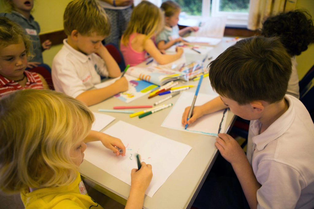 children drawing in a workshop