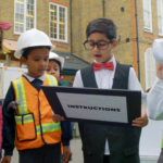 child reading off a board