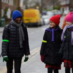 children talking and smiling in the street