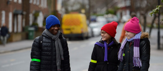 children talking and smiling in the street