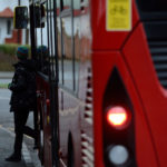 pupil getting of london bus