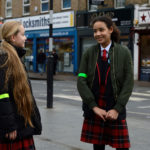 two girls talking in the street