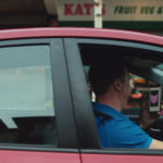 Pink Kittens - distracted driver looking at his mobile phone