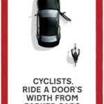 cyclists, ride a door's width from packed cars
