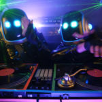 Two people with robot heads DJing